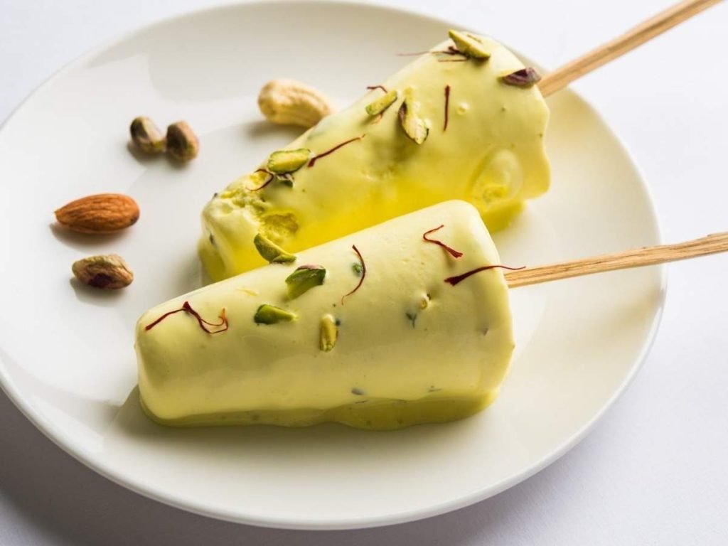 Golden kesar kulfi with pistachios and almonds, served in small bowls