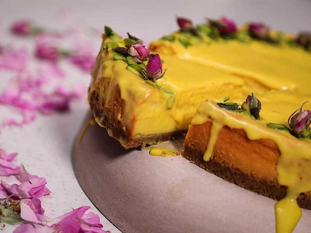Golden saffron cheesecake with a creamy filling, served on a white plate