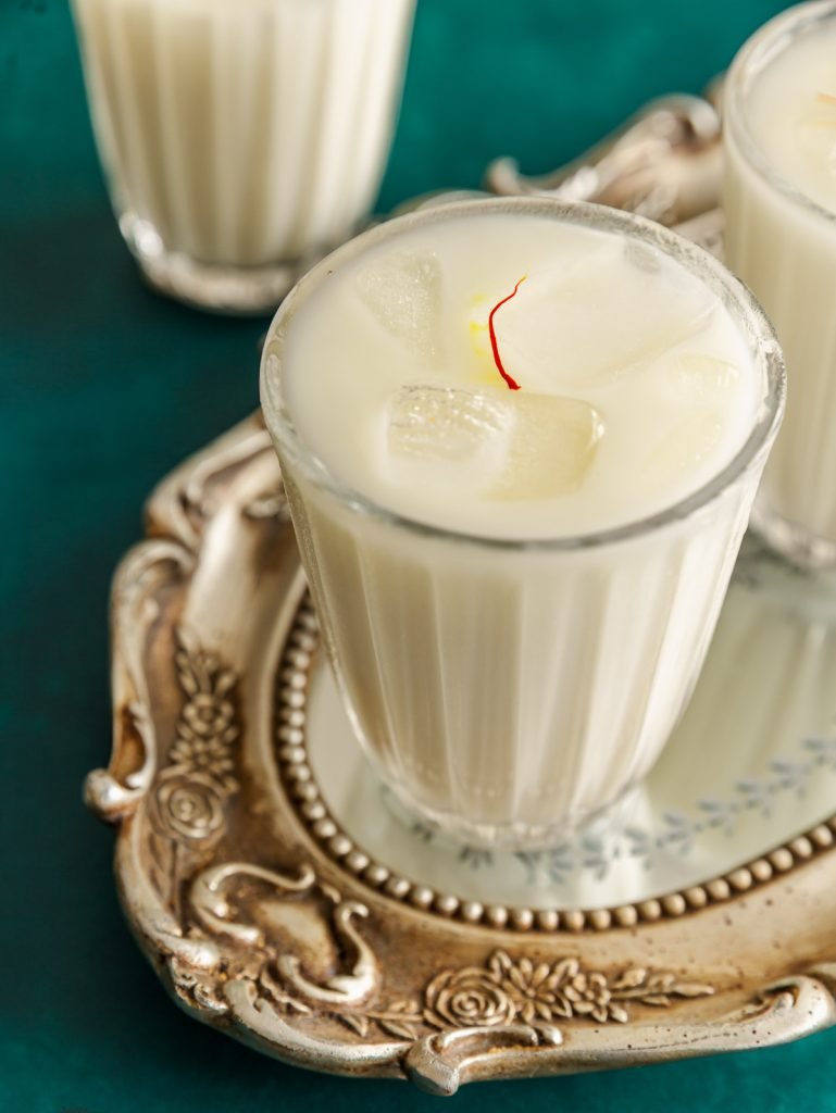 Chilled saffron-cardamom horchata with ice and a cinnamon garnish