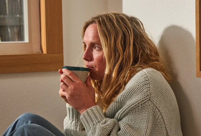 Woman relaxing at home with a cup of saffron tea