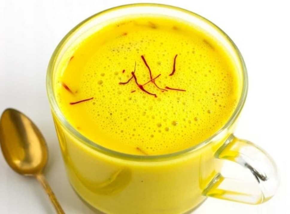Warm golden kesar doodh Indian saffron milk in a ceramic cup