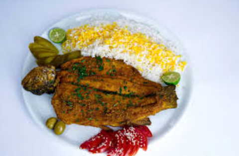 Salmon fillet served beside fluffy golden saffron rice