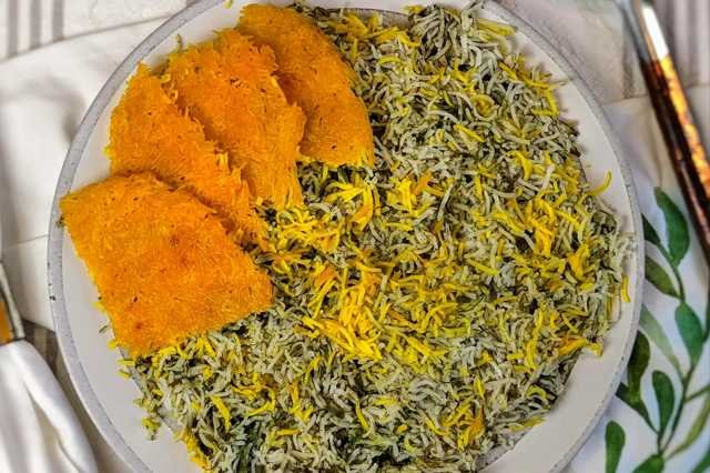 Persian sabzi polo herb rice with a golden saffron accent